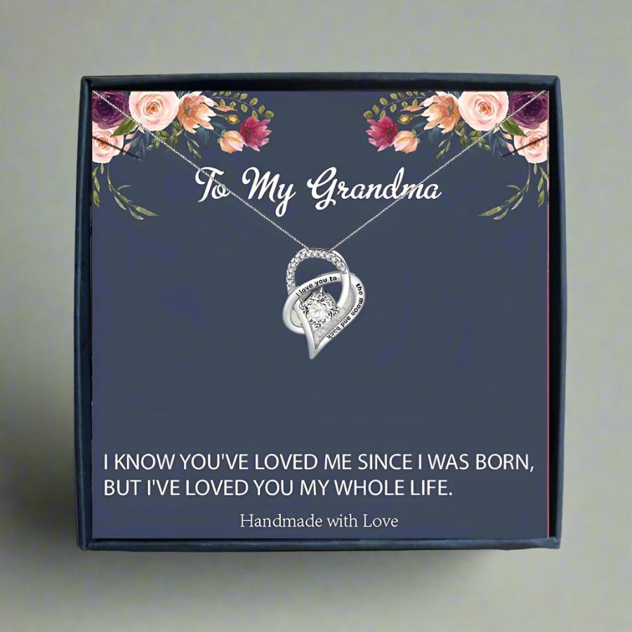 someone holding a card black box with a silver heart necklace for my grandma