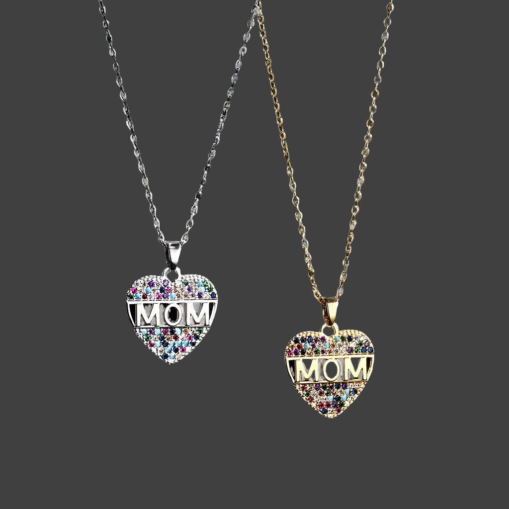 A pair of heart MOM pendants necklace on a black canvas