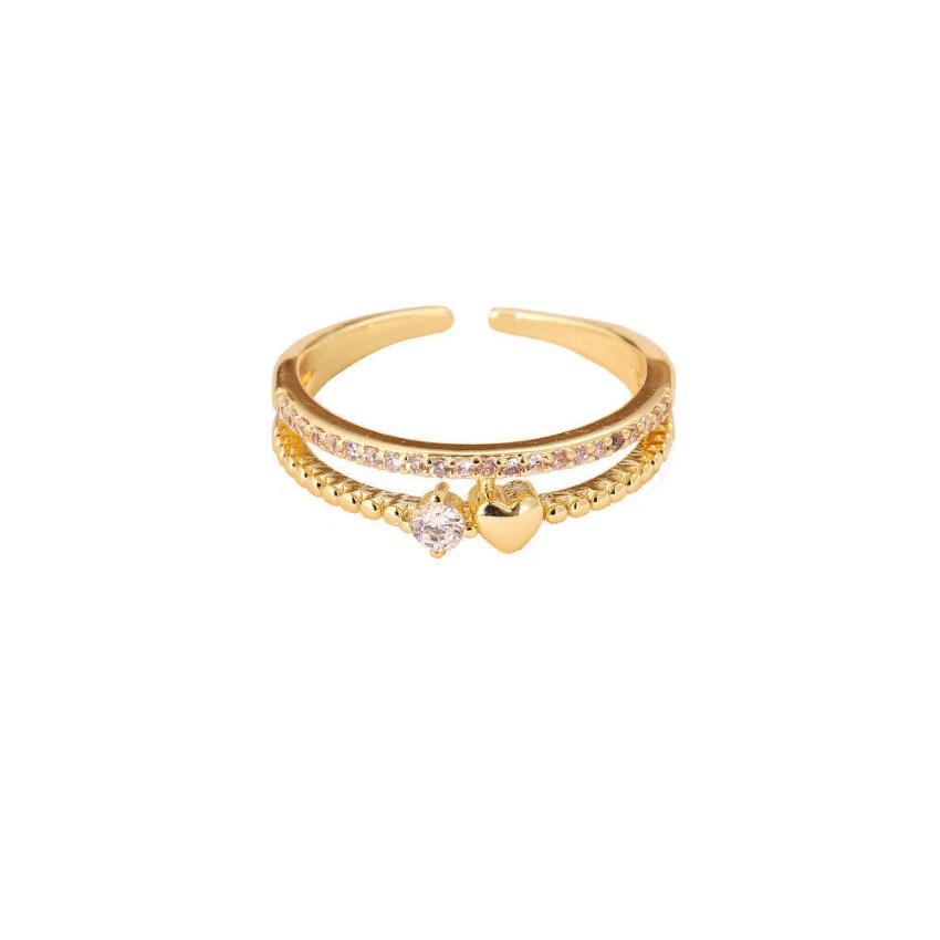 An elegant heart shape gold ring on a white canvas
