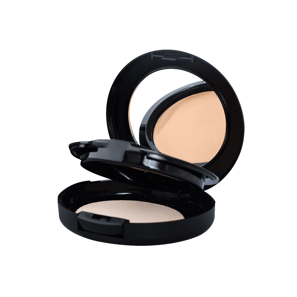A compact concealer round container opened with a mirrow