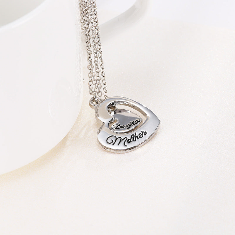 2 silvers hearts for mother and daughter on a silk surface
