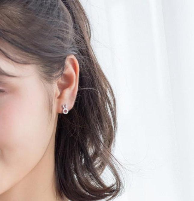A young adult girl wearing a rabbit earring