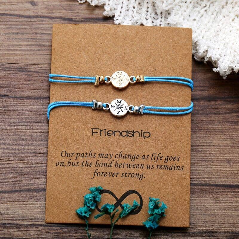 2 friendship bond bracelets with a message over a wooden surface