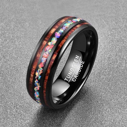 Luxurious Black and Gold Tungsten Carbide Ring with an intricate opal inlay design in a grey background