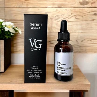 a bottle of serum vitamin C beside its packing with logo