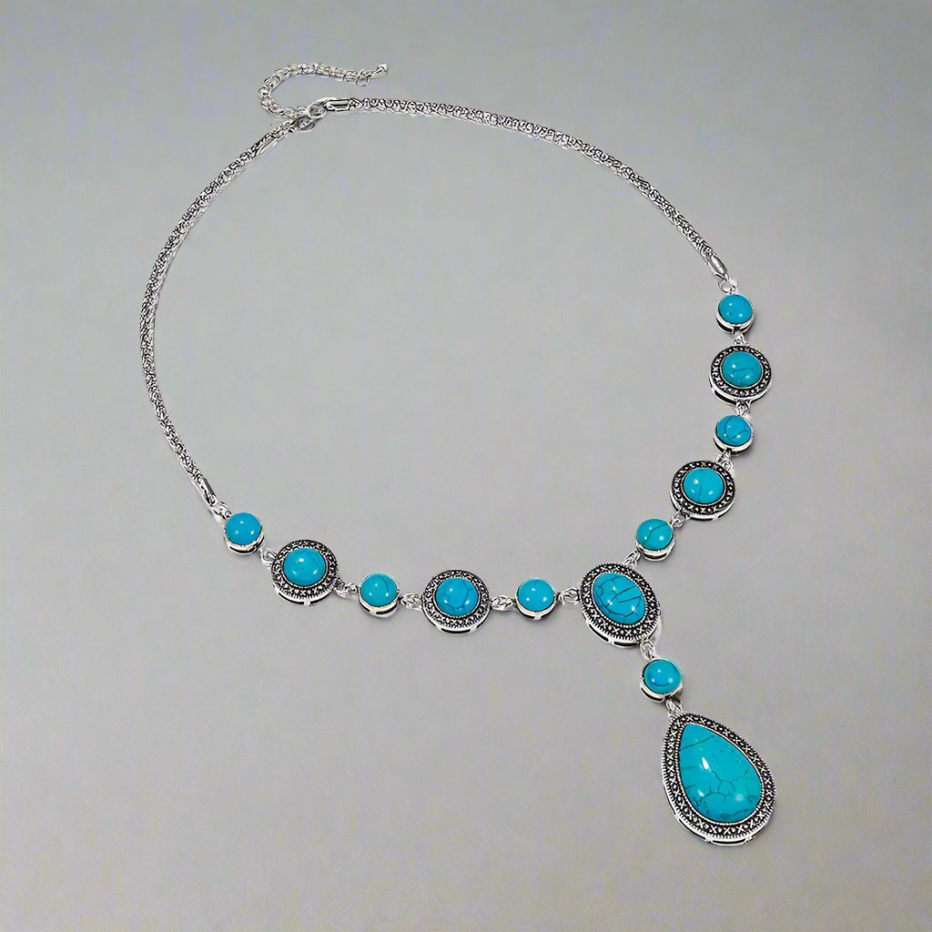 “An eco-friendly, polished alloy necklace featuring a water drop-shaped pendant with blue turquoise gemstones