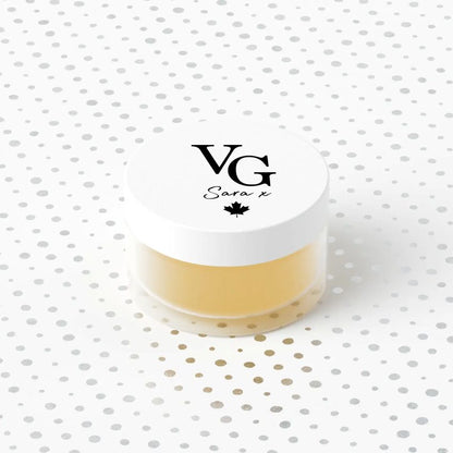 Jar of cream with a white lid featuring 'VG' branding on a polka dot background