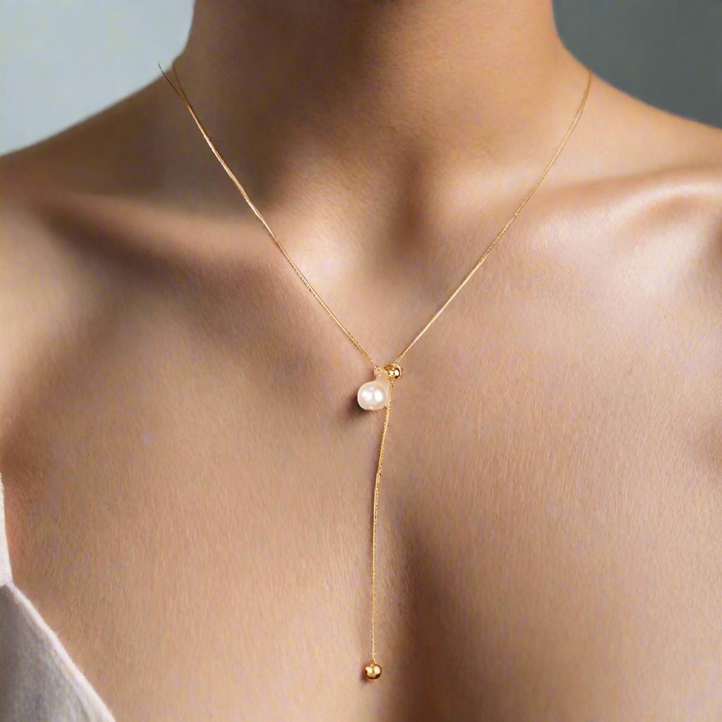 A woman wearing a red wool shirt and a gold necklace