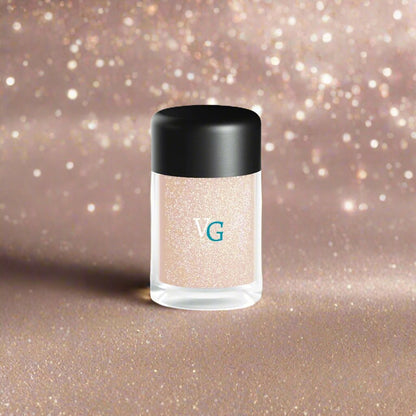 A container of dust glitter on a  brown background with sparkling powder n the background