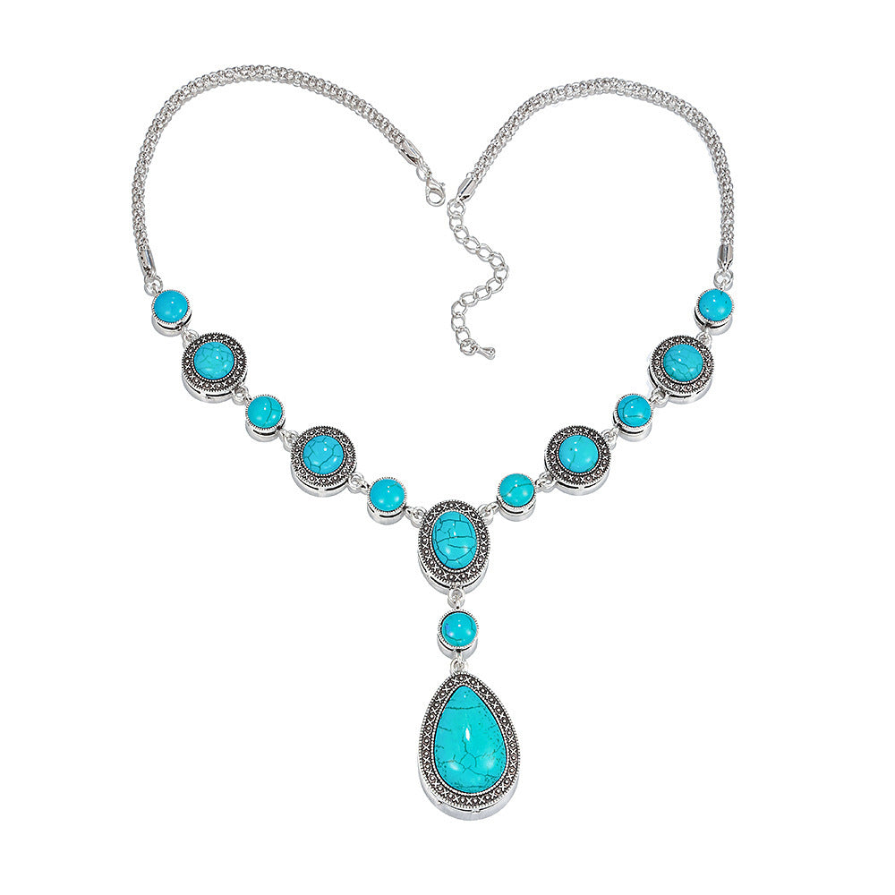 “An eco-friendly, polished alloy necklace featuring a drop-shaped pendant with blue turquoise gemstones