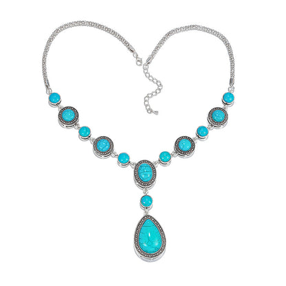 “An eco-friendly, polished alloy necklace featuring a drop-shaped pendant with blue turquoise gemstones
