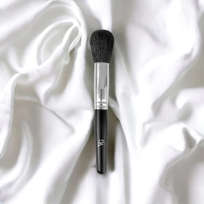 Brush Powder Blush Blender lying on a pristine white surface