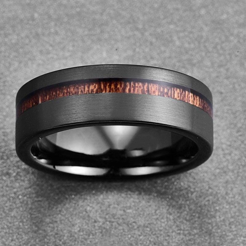 close view of a tungsten black ring on a grey granulated background