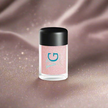 A bottle of Cruelty-Free Mineral Stardust Glitter with a pink hue on a white background