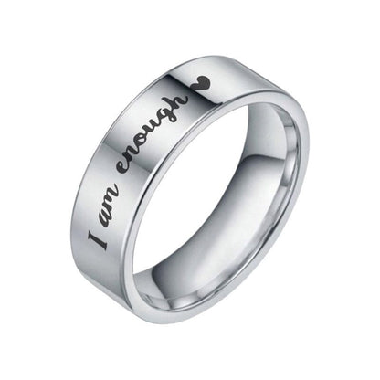 Side view of a stainless steel ring with a message on a white background